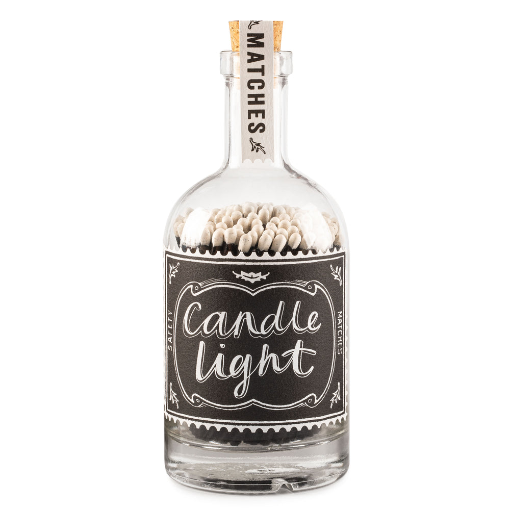 glass bottle filled with matches with decorative candle light label