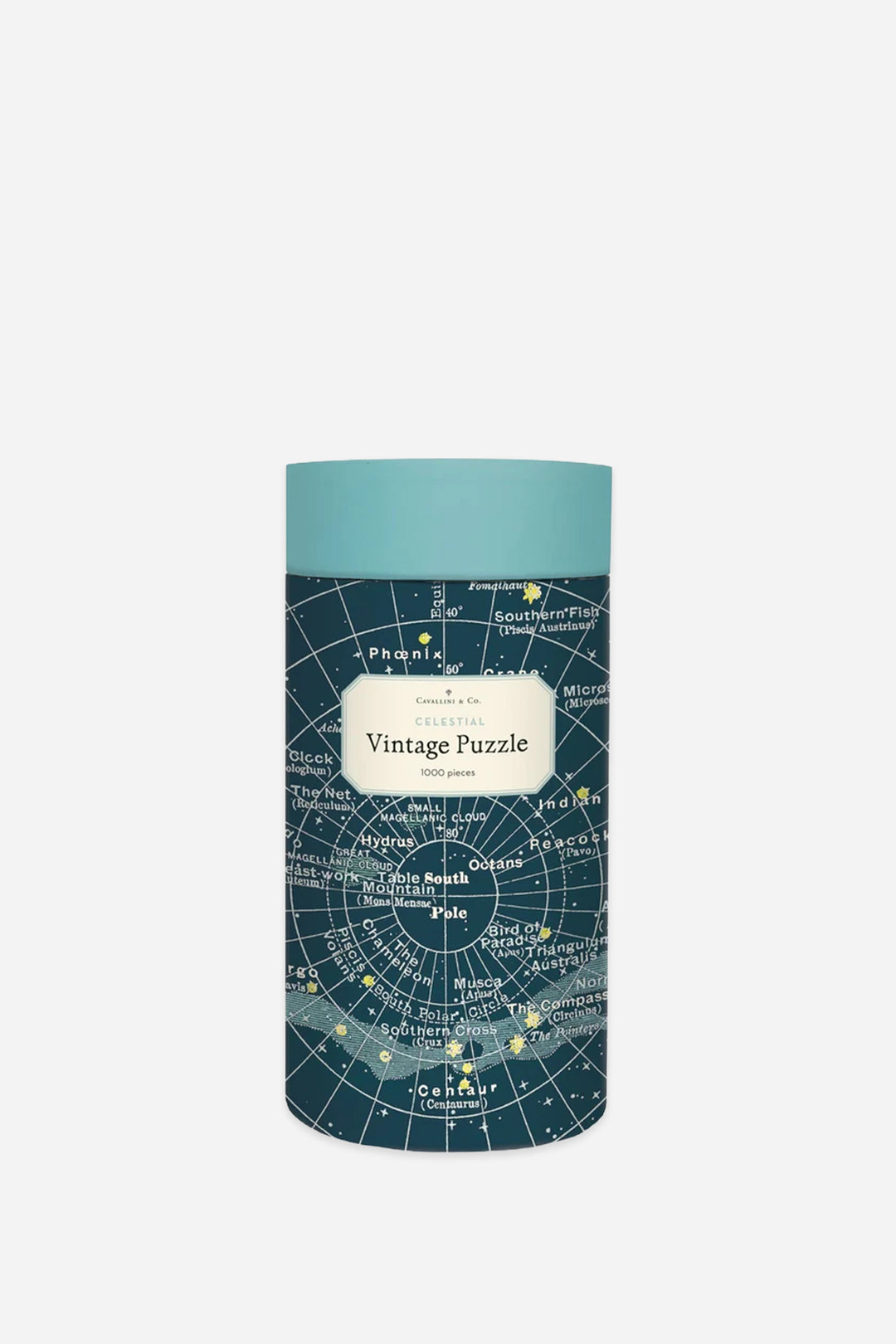 A cylindrical puzzle tin with a light teal lid and a dark teal map-patterned body, featuring a cream label that reads &