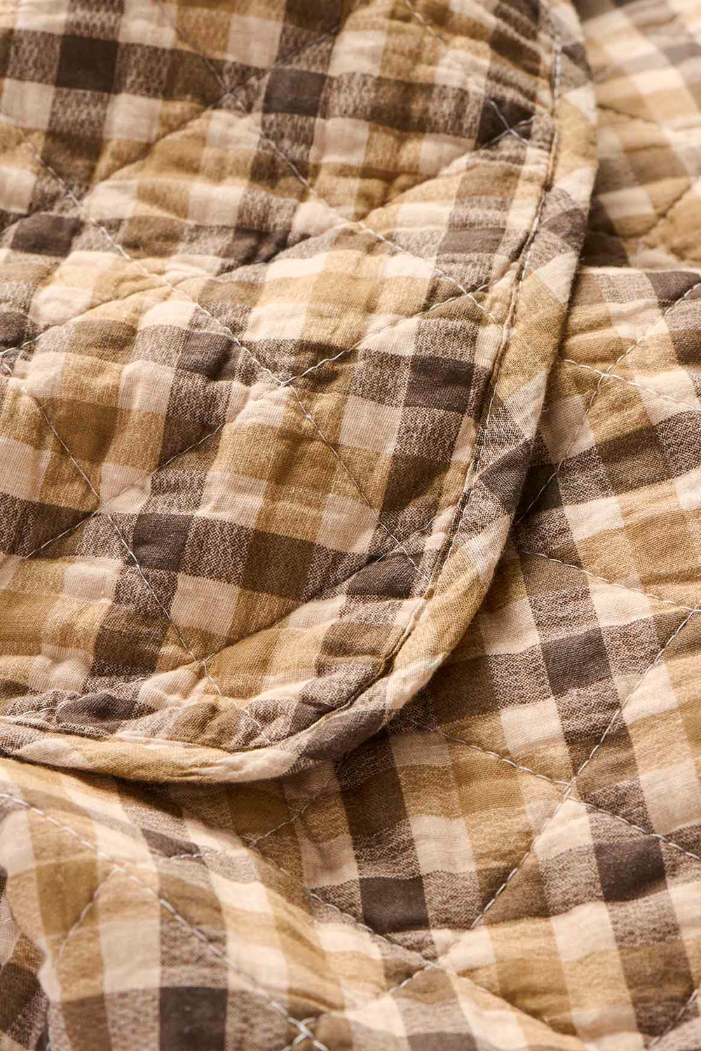 Close-up of a quilt with brown and beige checkered pattern