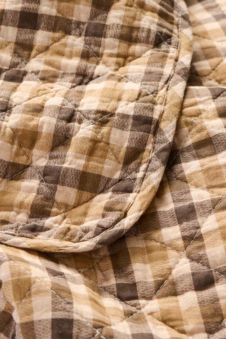Close-up of a quilt with brown and beige checkered pattern