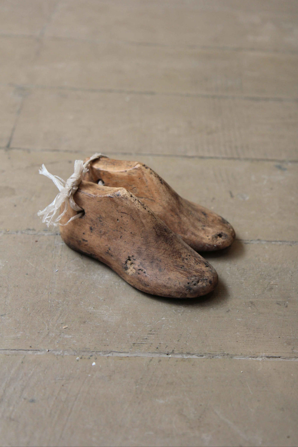 Pair of old wooden shoe lasts on a wooden floor