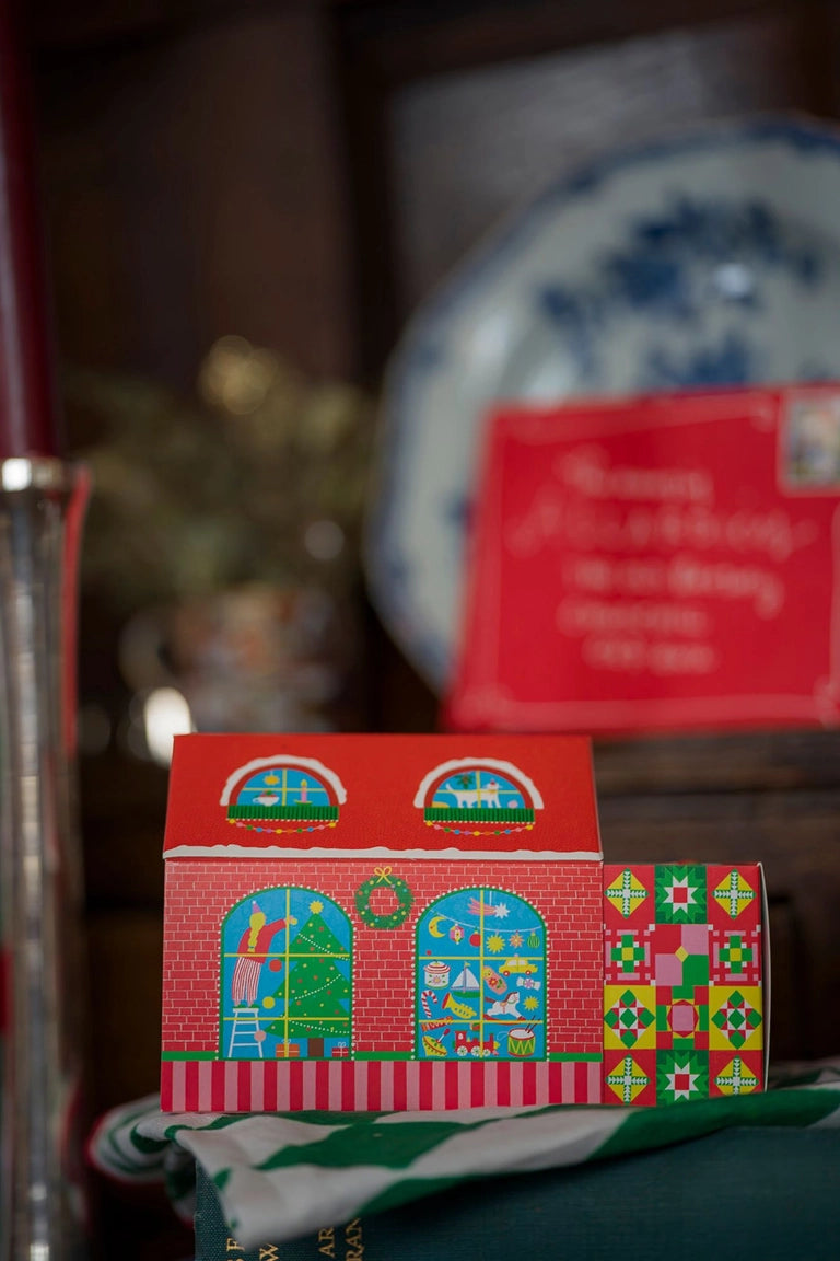 Small red box with colorful patterns on a surface with a blurred background
