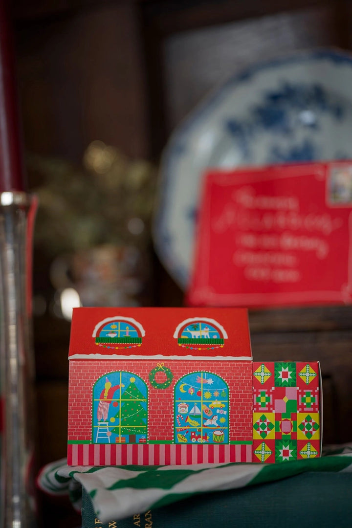 Small red box with colorful patterns on a surface with a blurred background