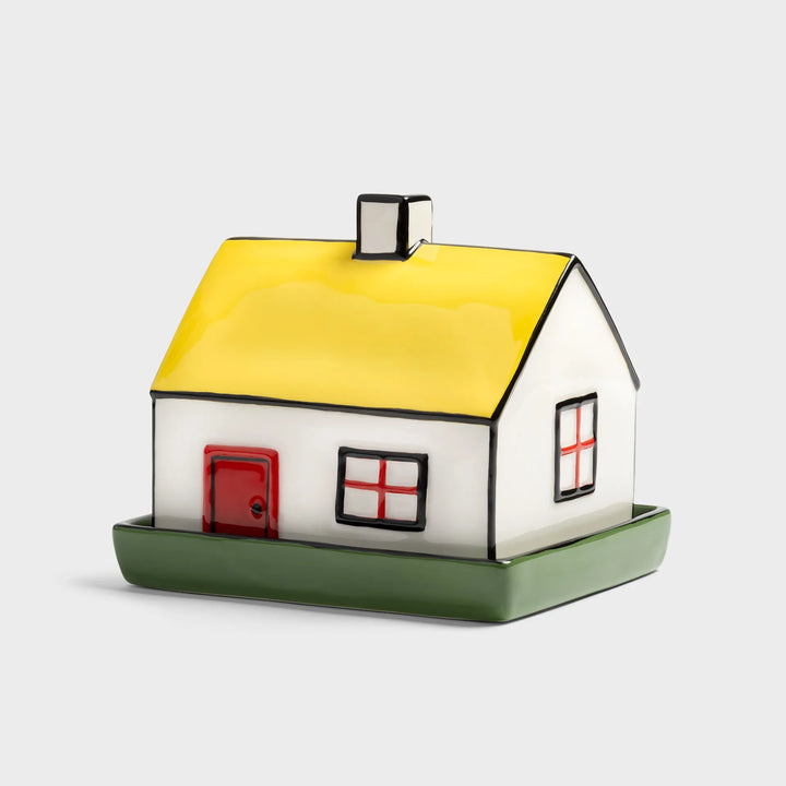 cottage-shaped butter dish with a yellow roof, red door, and green base