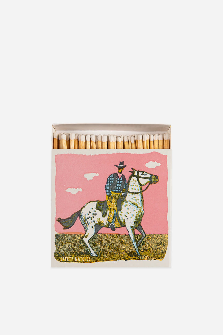 luxury matches with vintage cowboy print on pink background