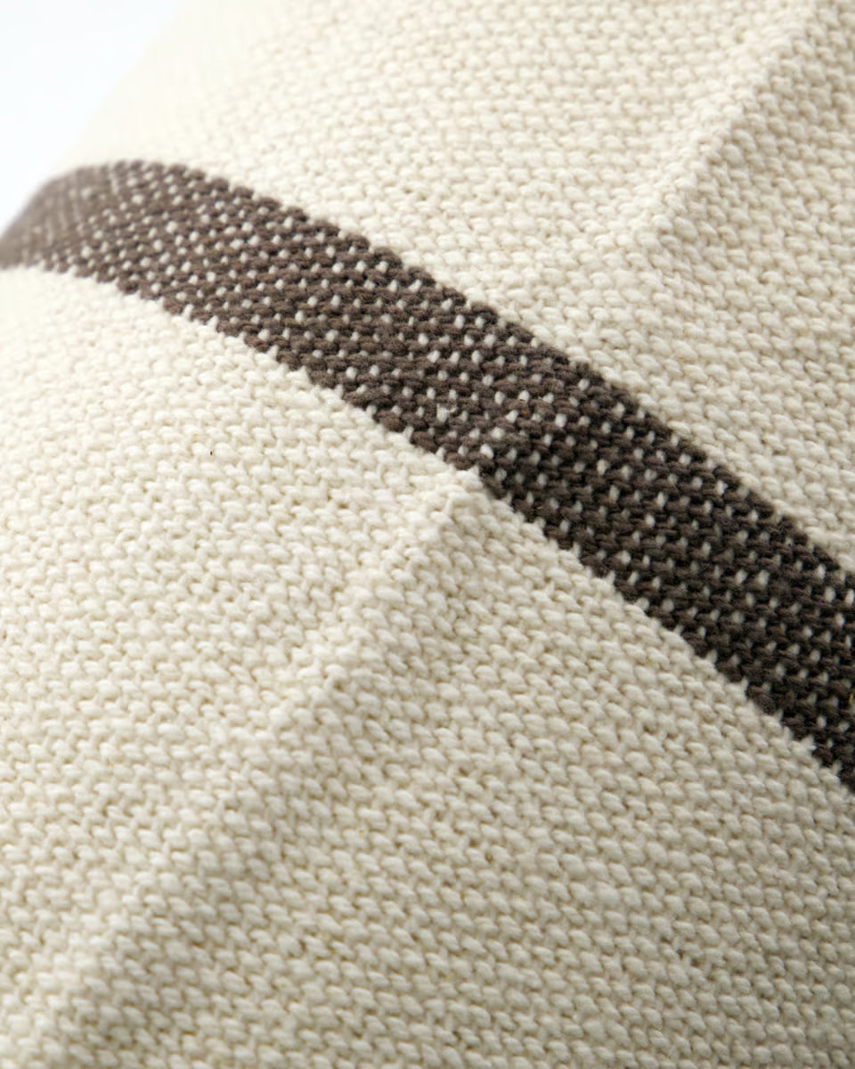 Close-up of a fabric with a black stripe on a beige background
