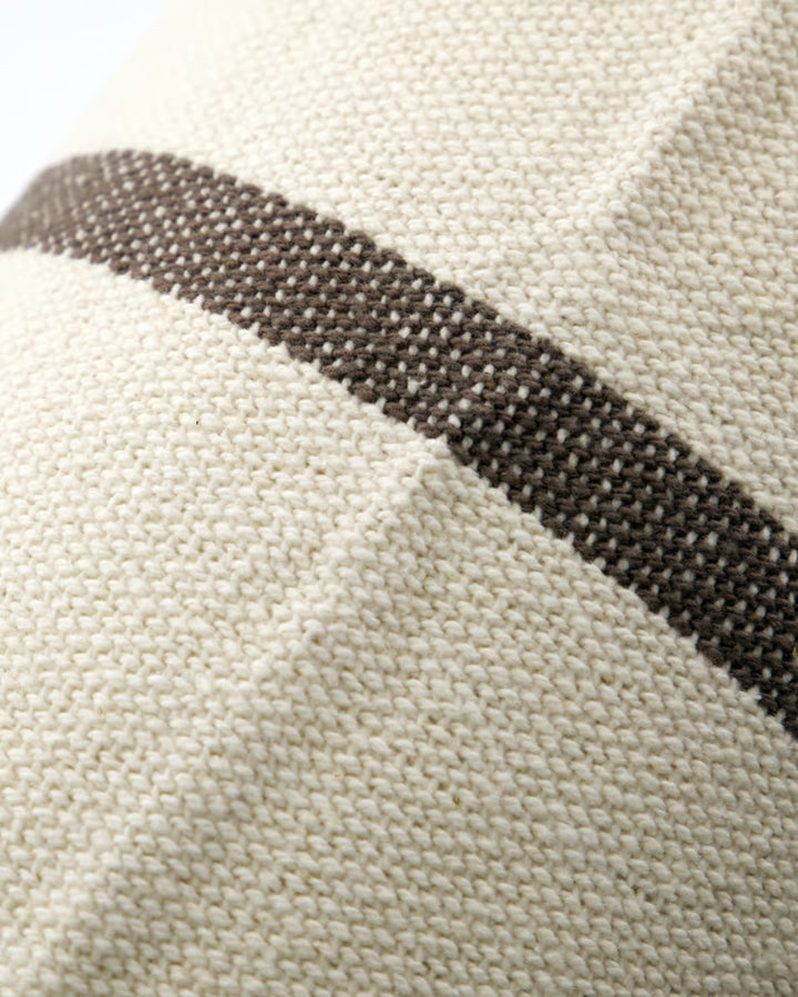 Close-up of a fabric with a black stripe on a beige background