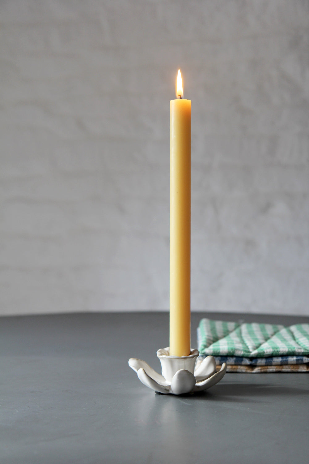 daffodil candle holder in cream with yellow dinner candle