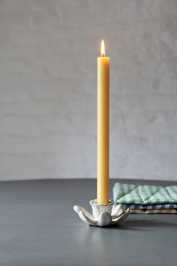 daffodil candle holder in cream with yellow dinner candle