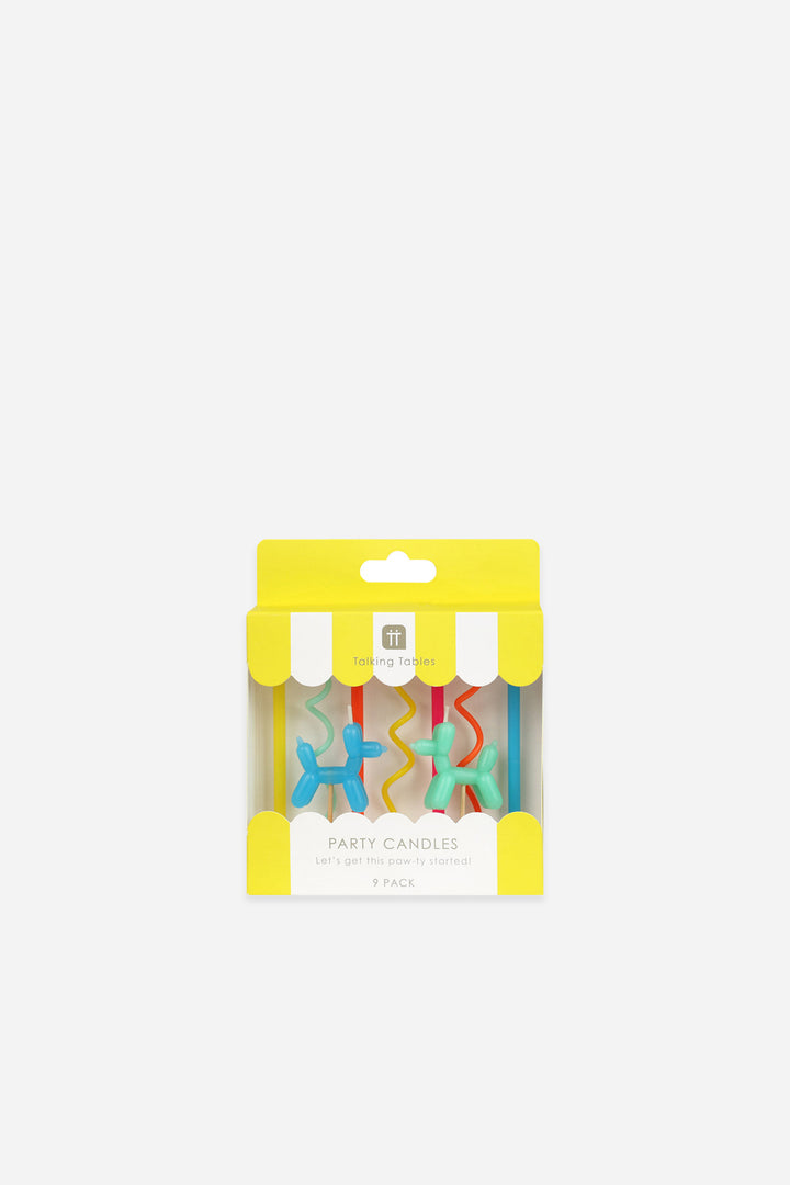 Packaged party candles with colorful designs on a white background
