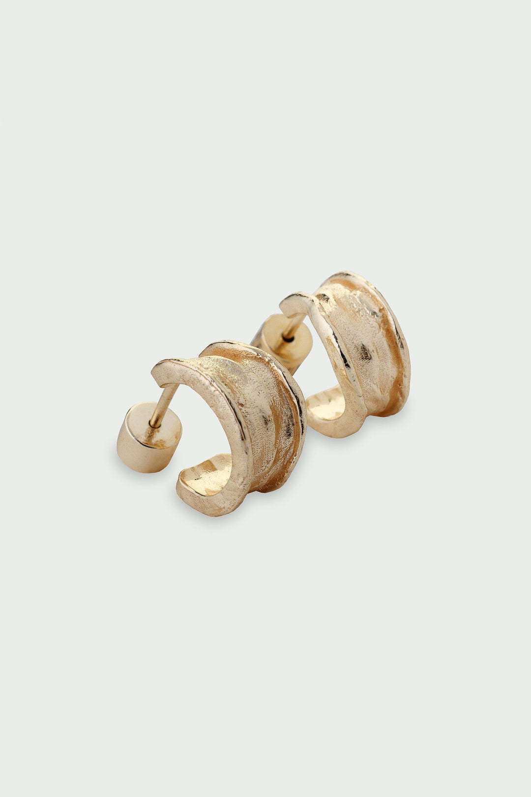 Pair of gold hoop earrings on a light gray background