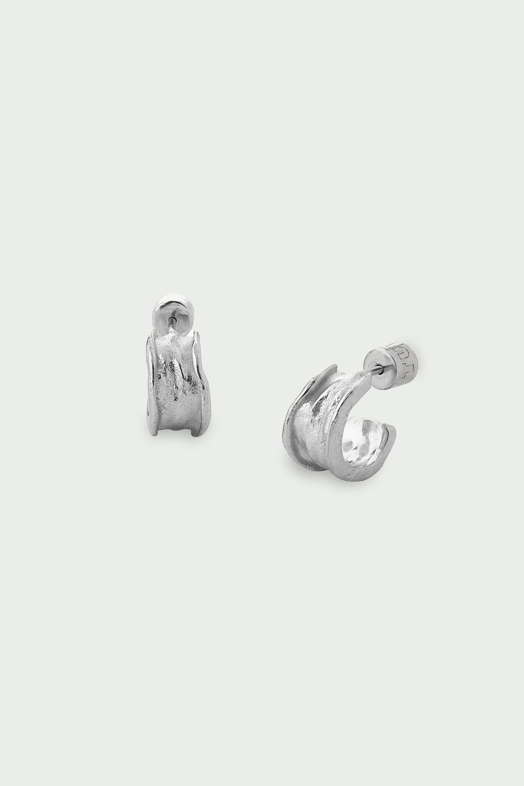 Pair of silver hoop earrings on a white background