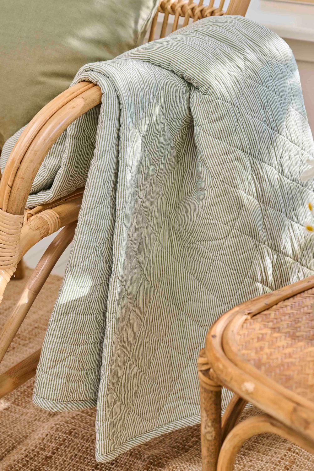 green stripe quilt over arm of chair