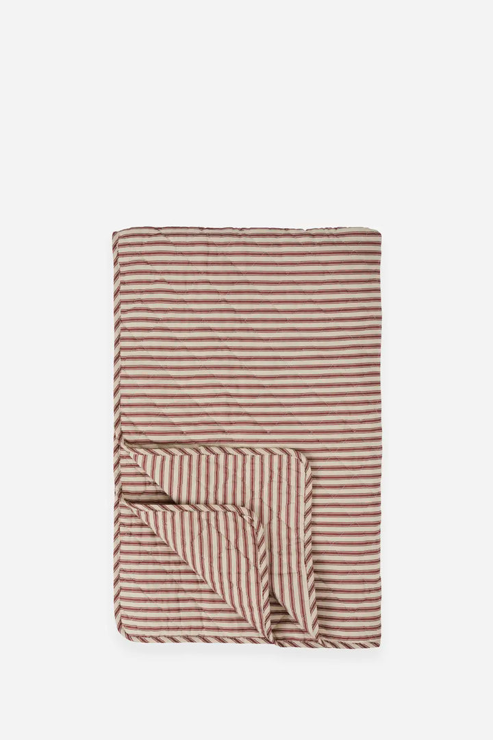 A folded striped blanket or throw in a warm brown and beige colorway, shown against a plain light gray background.