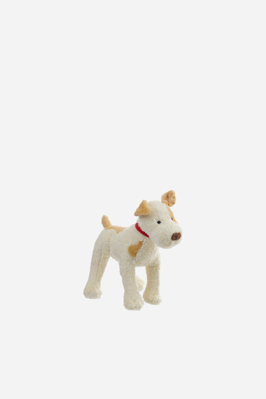 small eliot dog soft toy on grey background