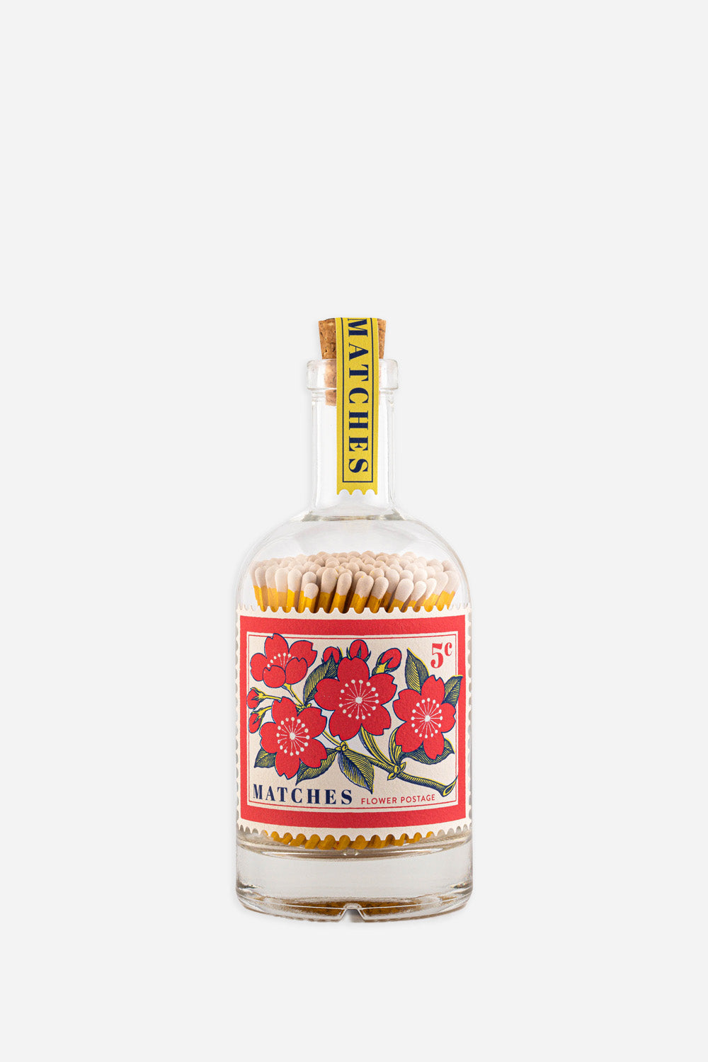 glass bottle filled with matches with decorative floral postage stamp label