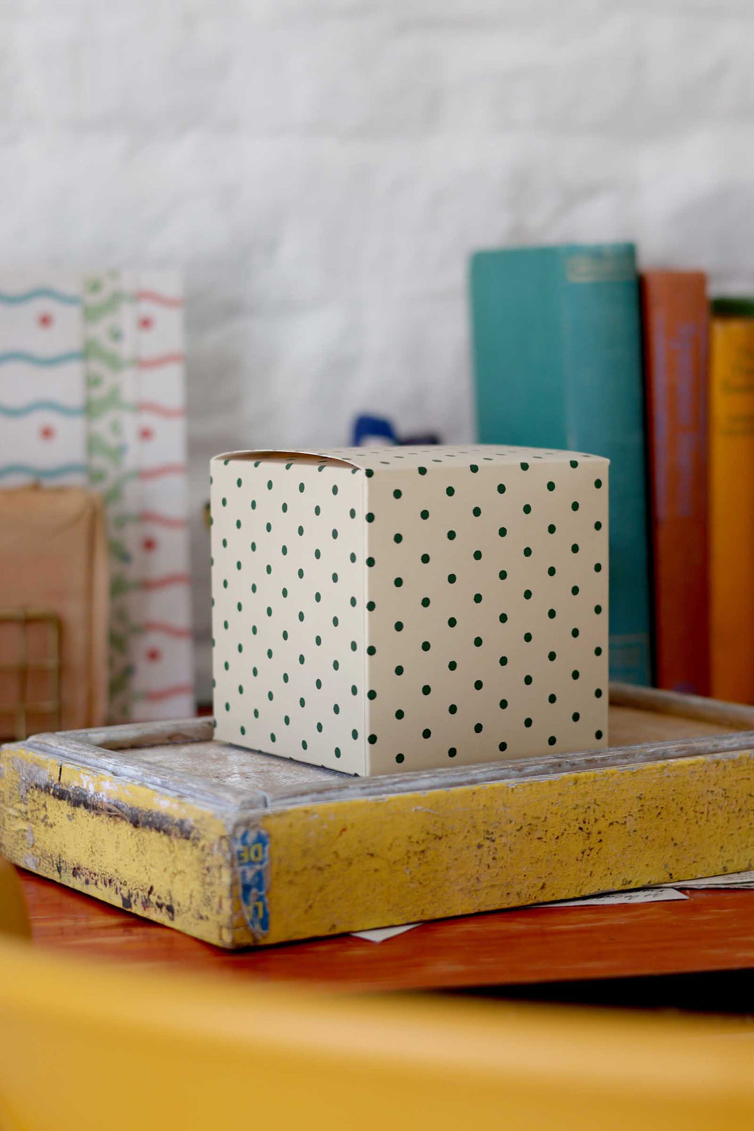 Polka dot box on a stack of books with a blurred background