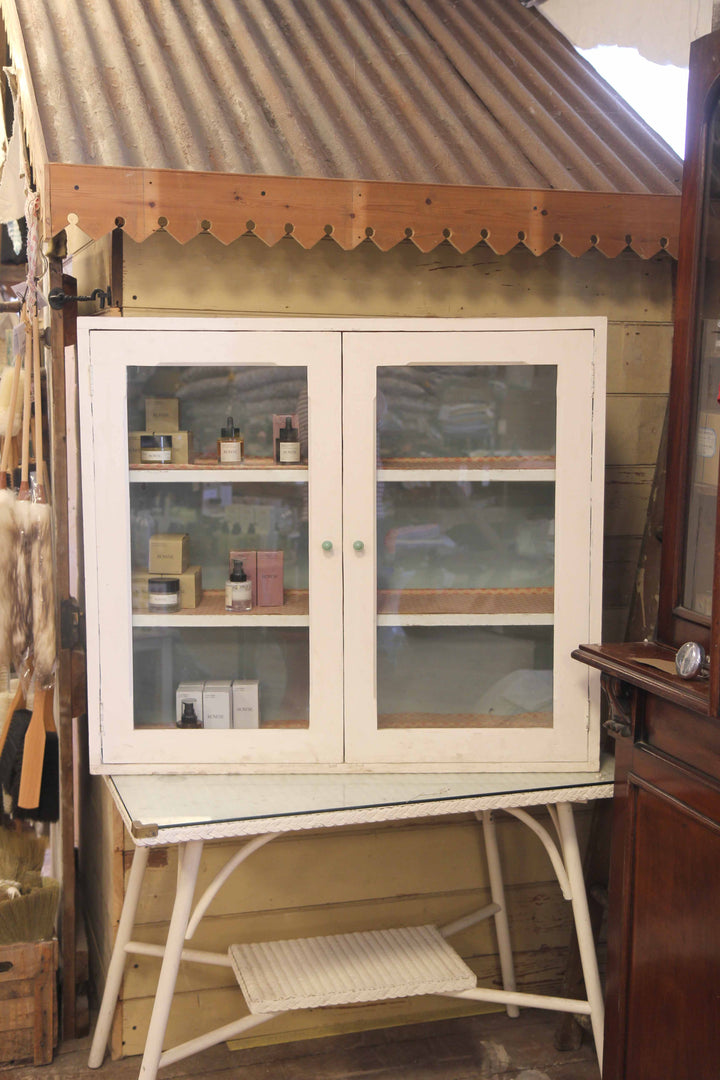 Vintage-style cabinet with glass doors in a rustic setting
