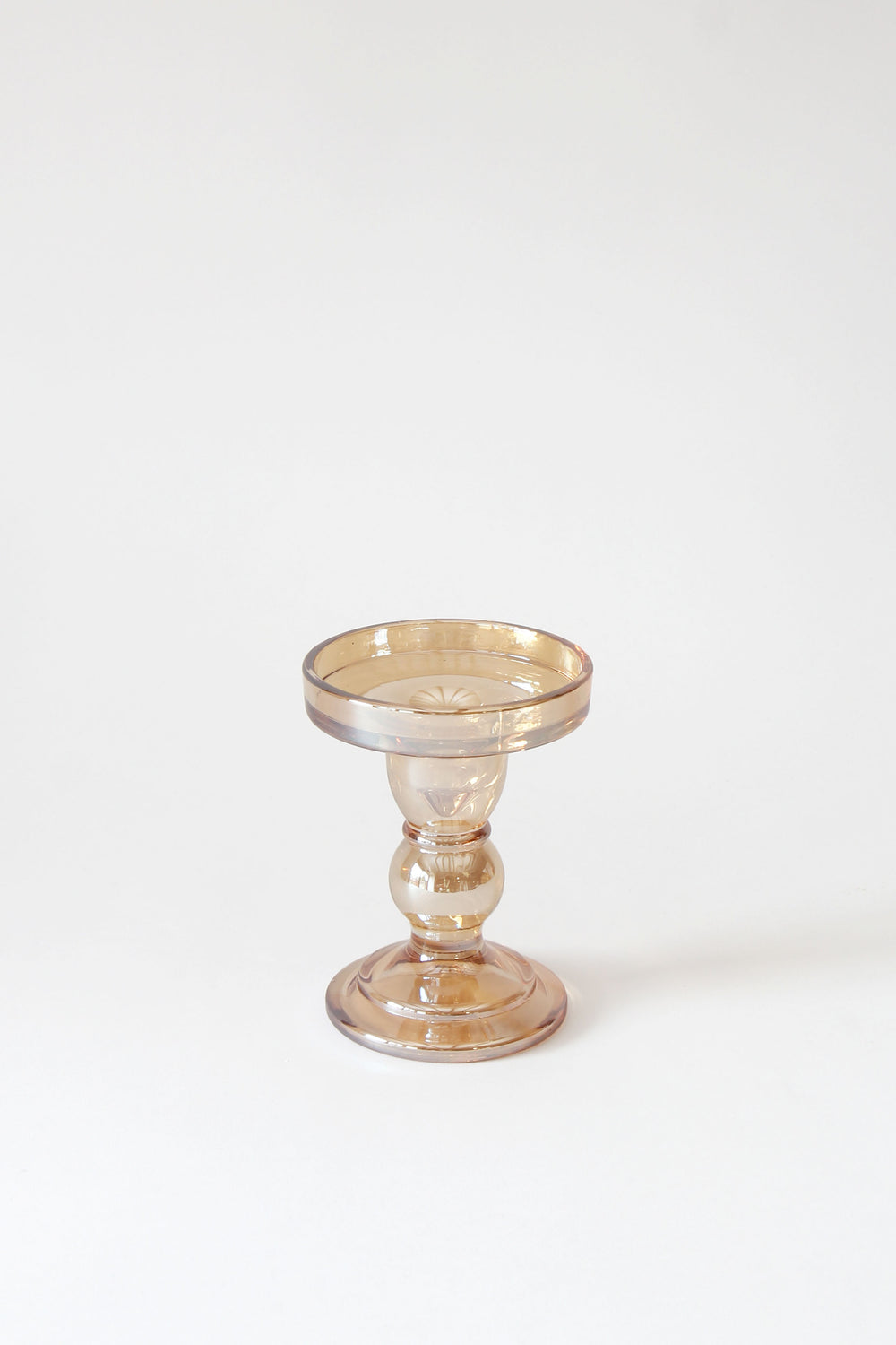 gold lustre glass candle holder on a white background
