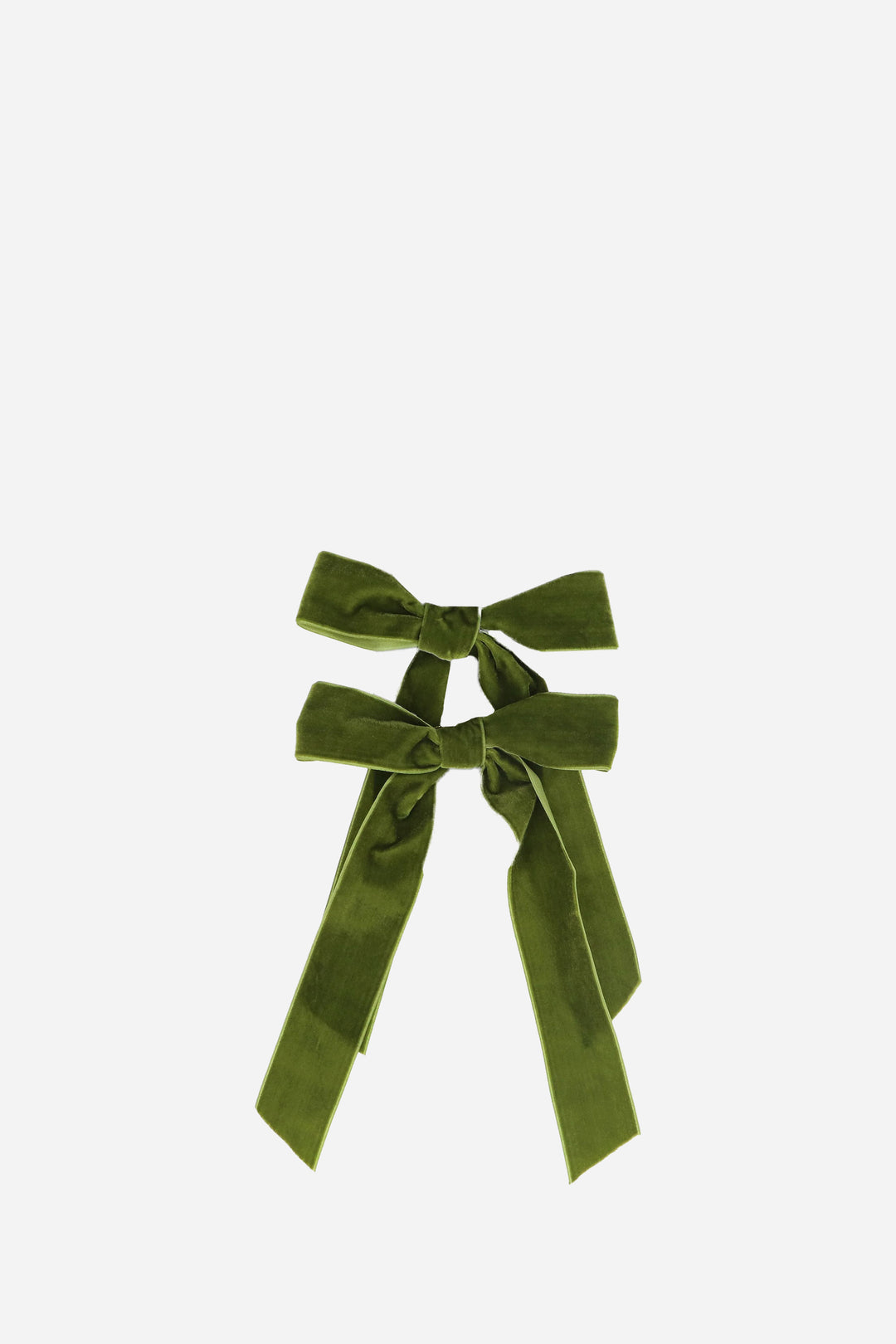 Two green velvet bows on a white background