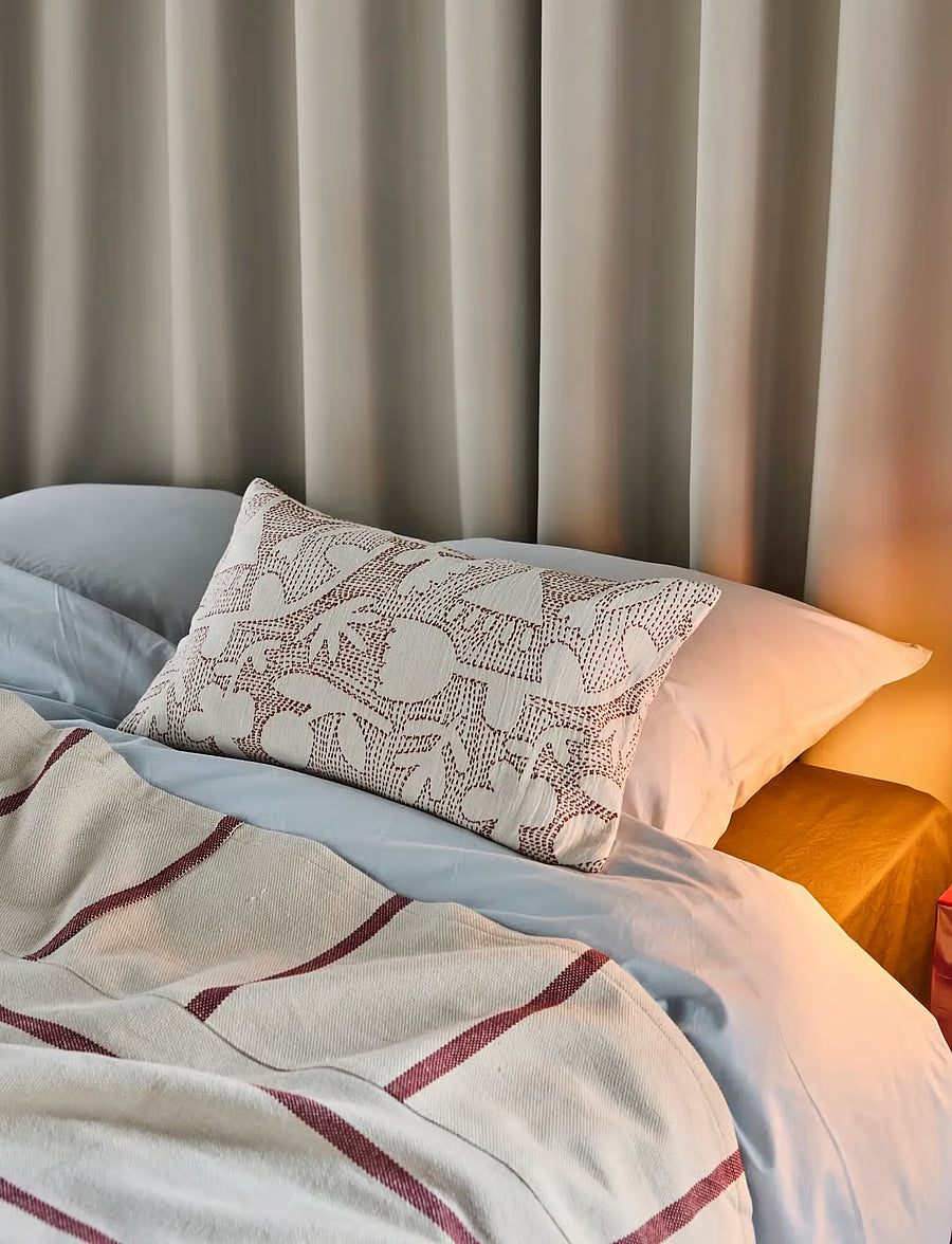 decorative kantha stitched cushion on bed