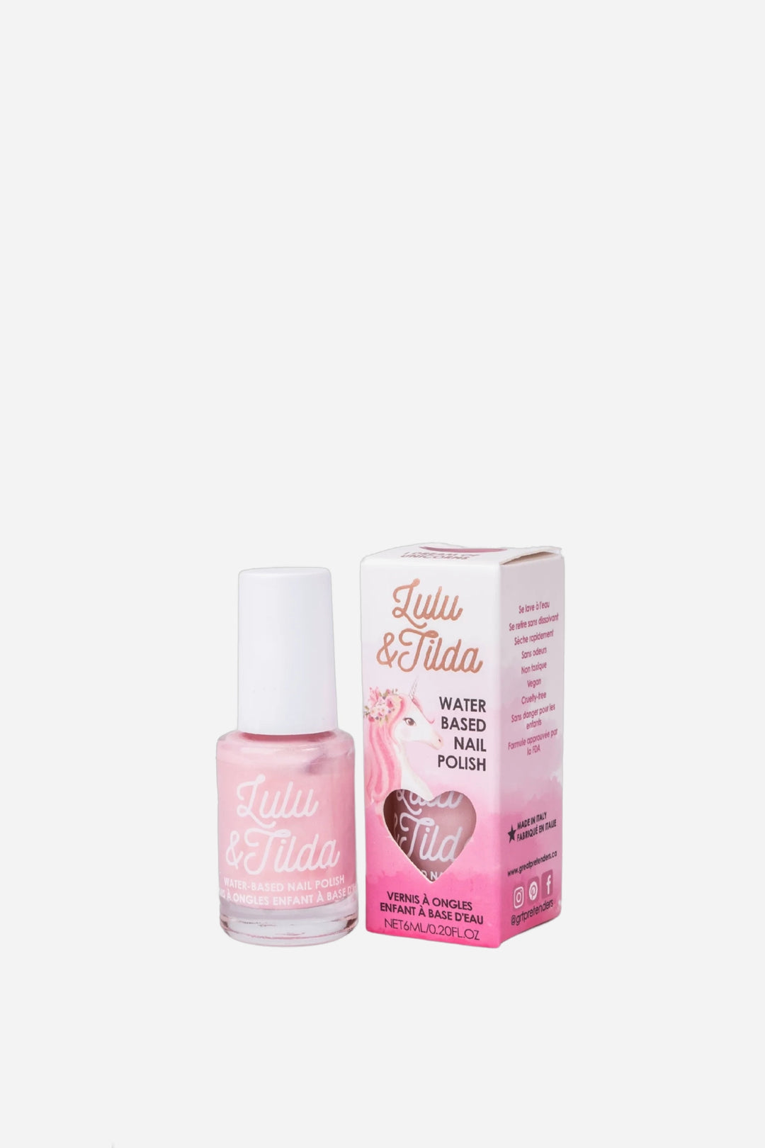 A bottle of Lulu &amp; Tilda pink water-based nail polish next to its pink packaging box, set against a plain light gray background.