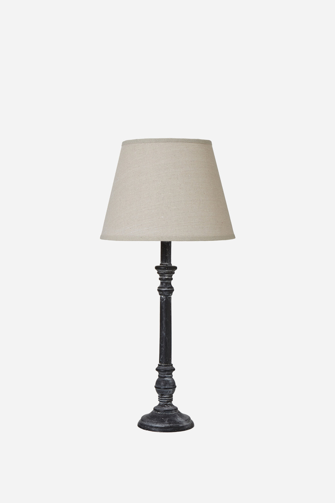 Table lamp with a beige shade on a white background