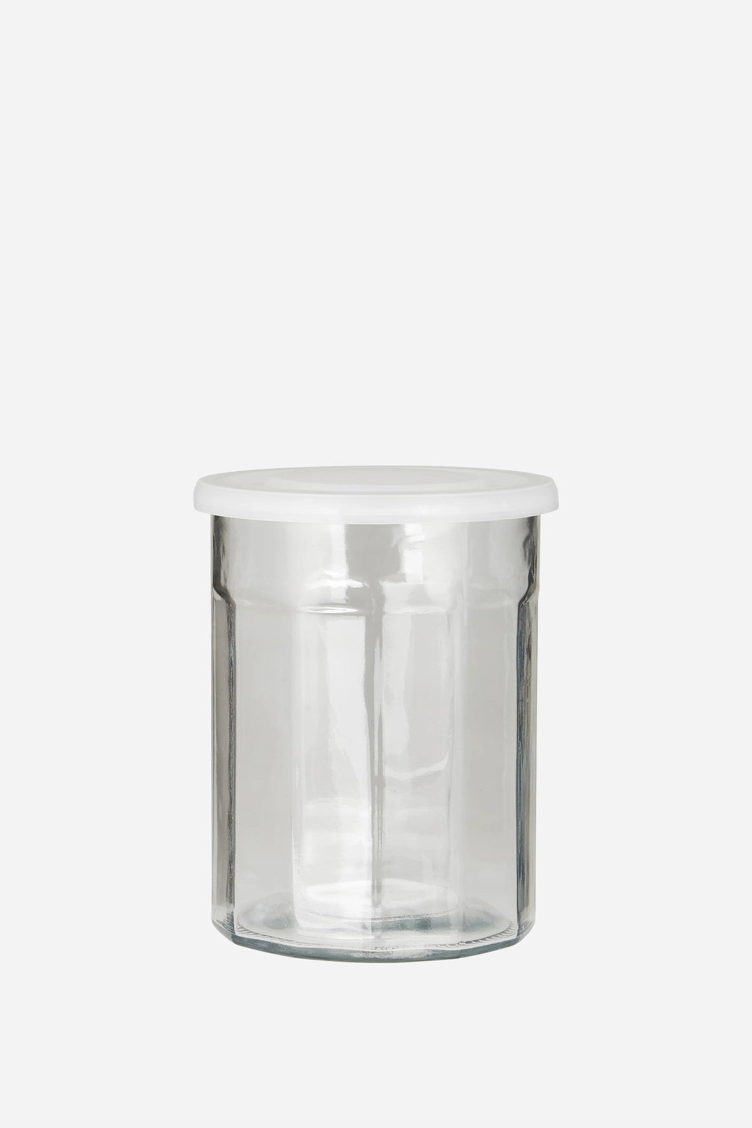 Clear glass jar with metal lid on a white background