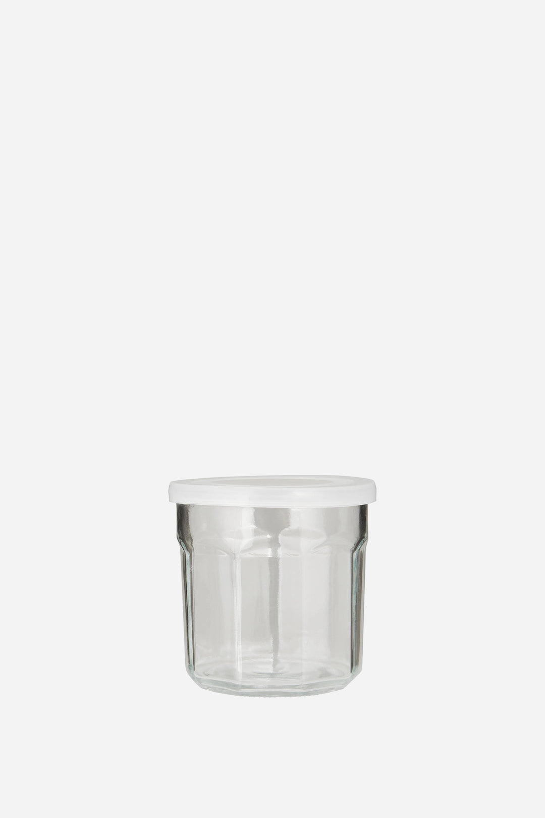 Clear glass jar with a white lid on a white background