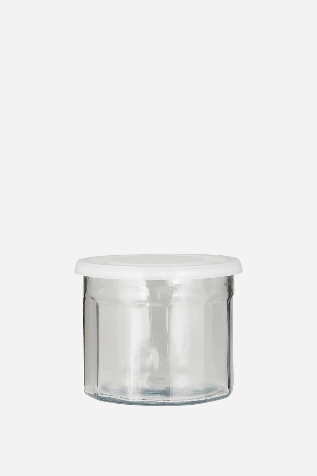 Clear glass jar with a white lid on a white background