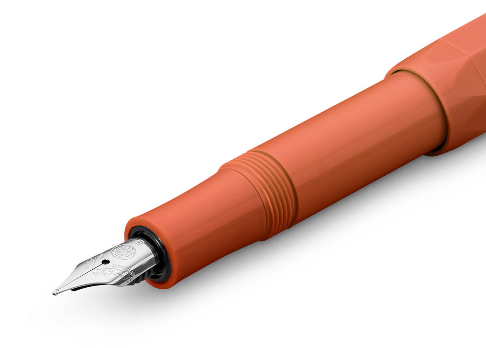Orange fountain pen on a white background