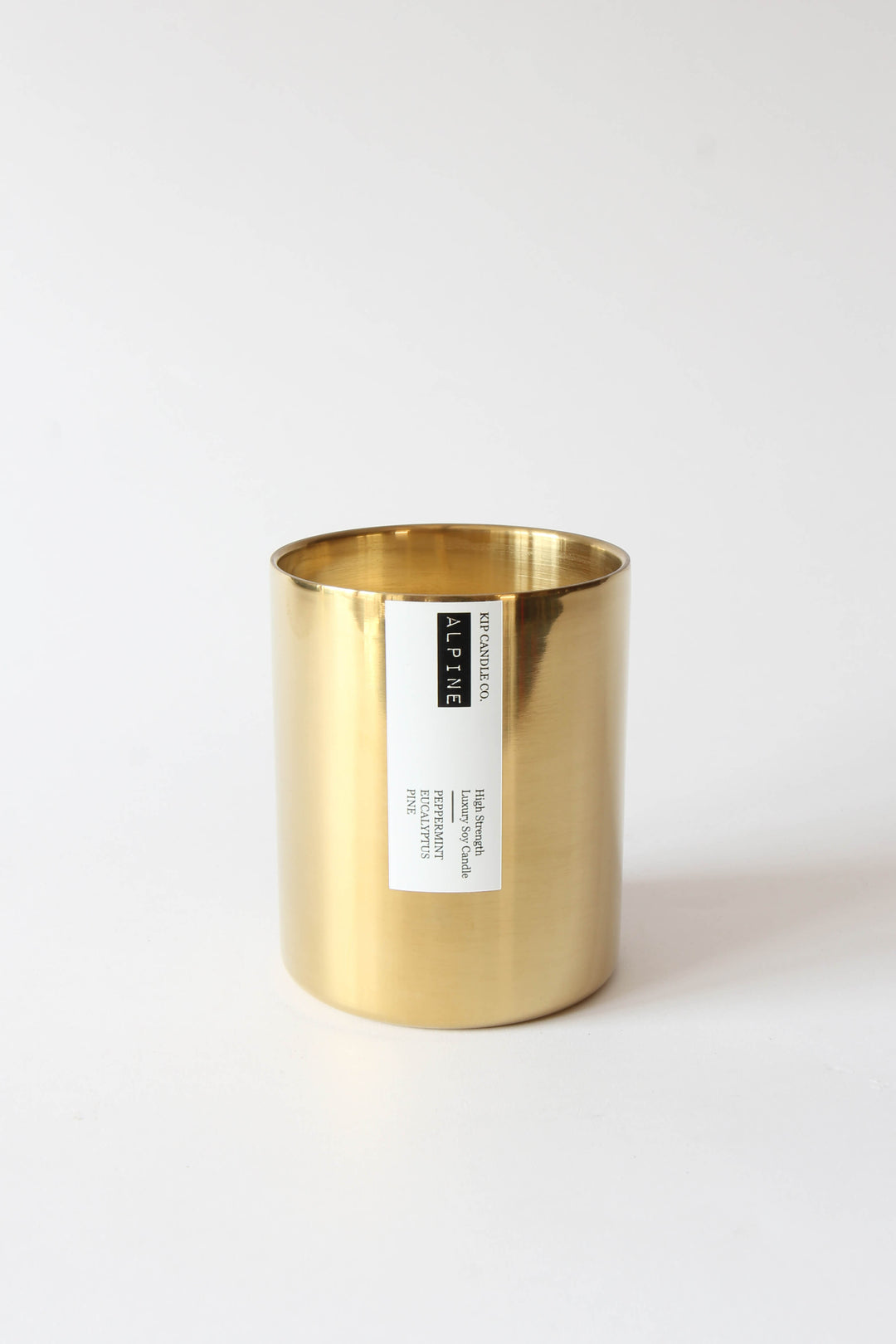 Gold candle holder with a label on a white background