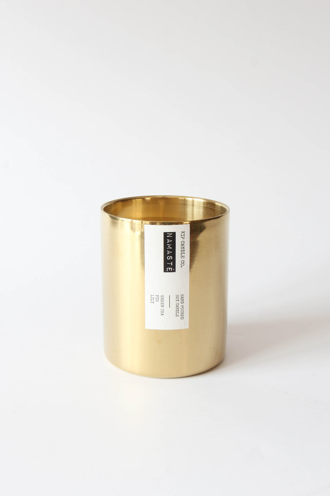 Gold candle holder with a label on a white background