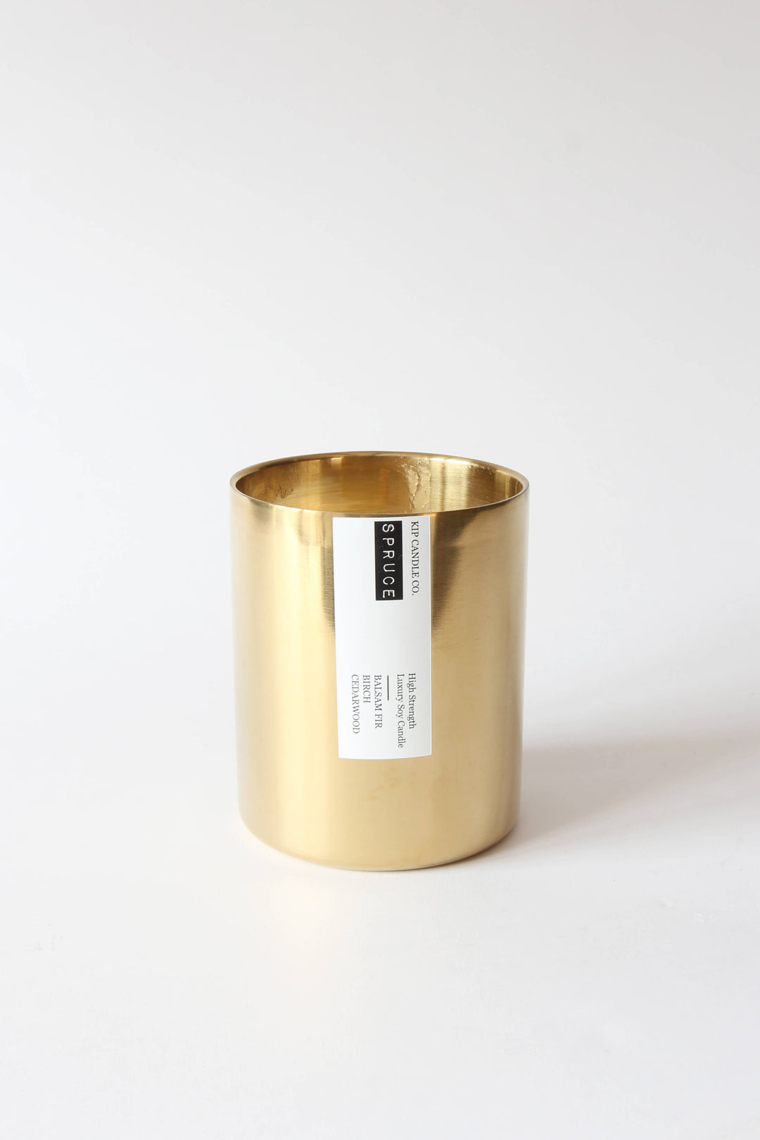Gold candle holder with a label on a white background