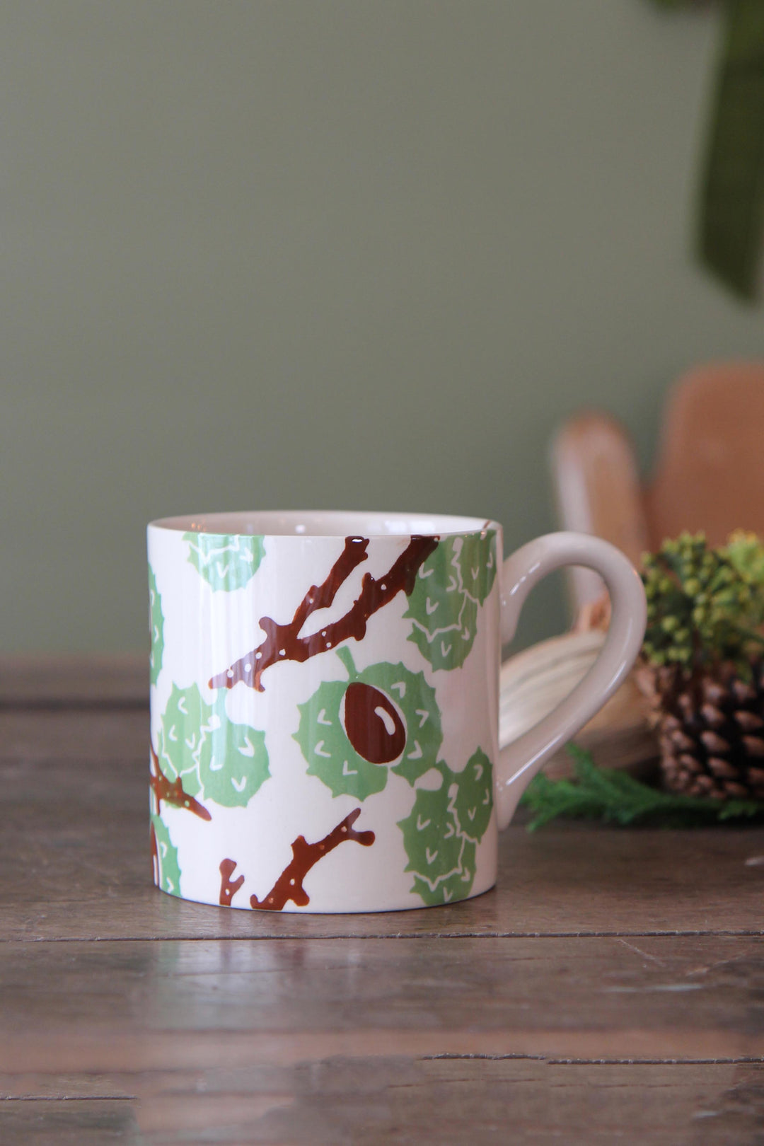 Mug with nature-themed design on a wooden surface