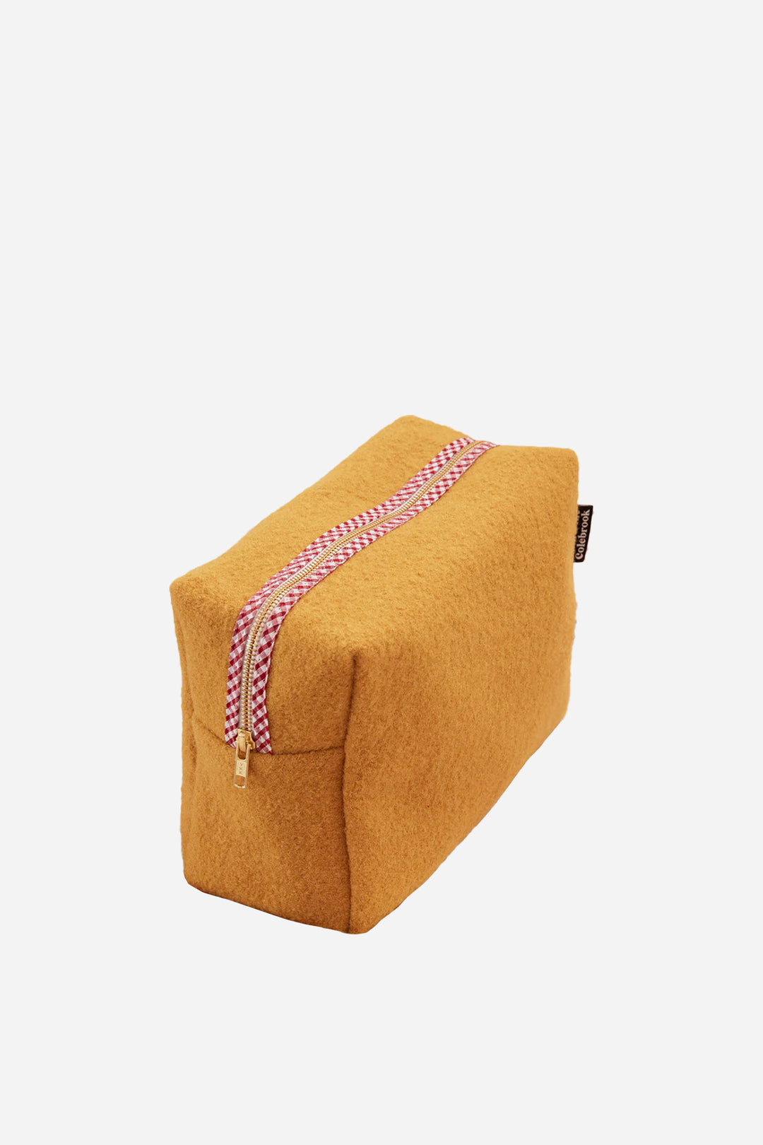 Yellow wedge-shaped pouch with a pink zipper on a light beige background