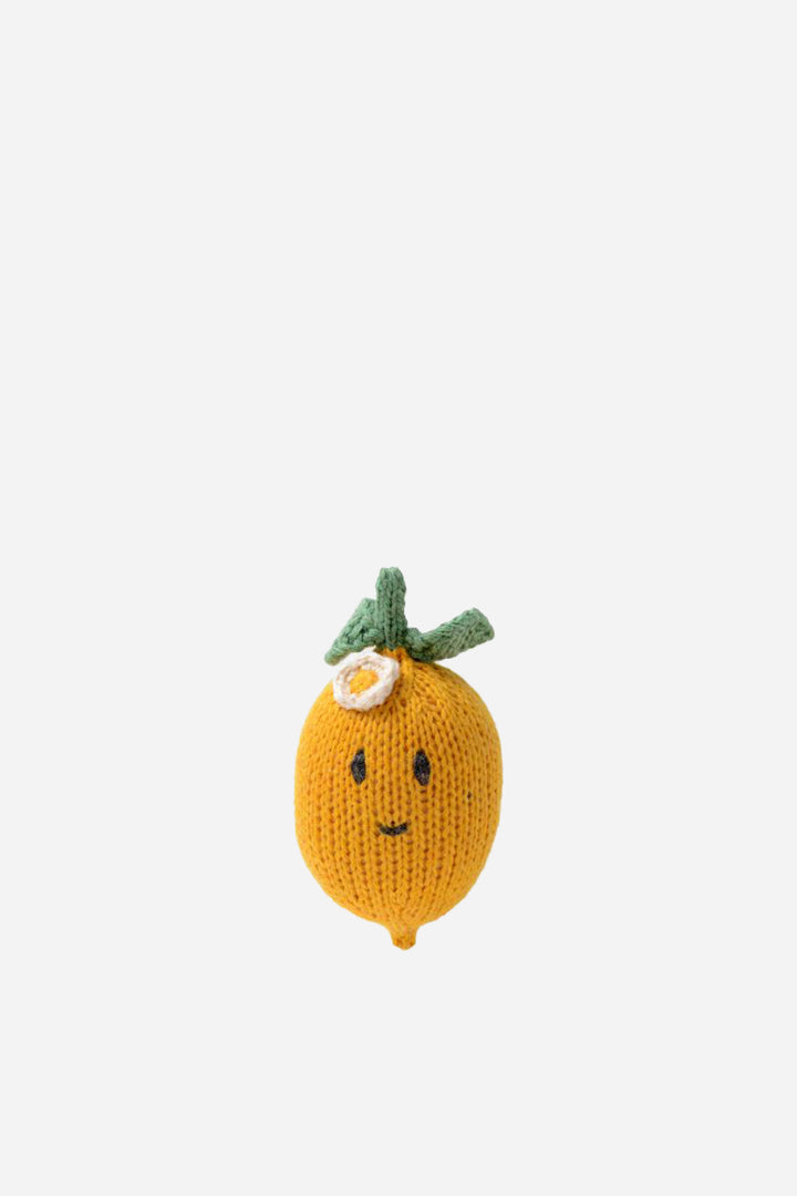 Knitted lemon toy with a face on a white background