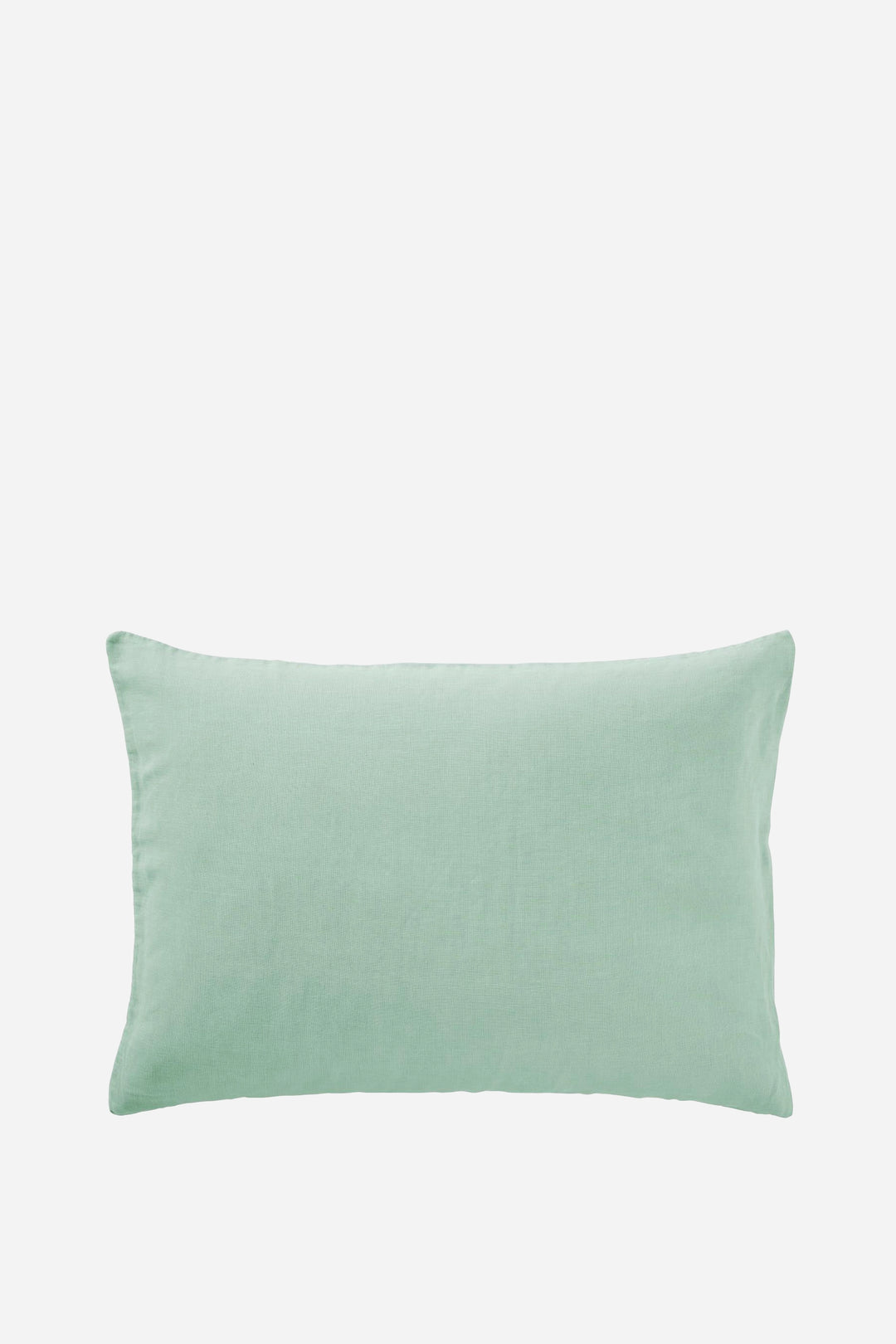 pistachio green linen cushion on light grey background