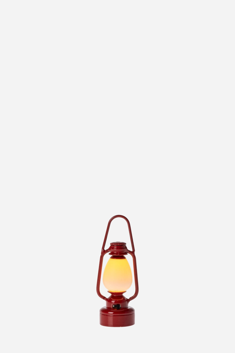 Red lantern with a glowing yellow light on a white background