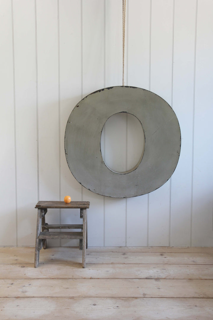 giant vintage metal letter O with stool