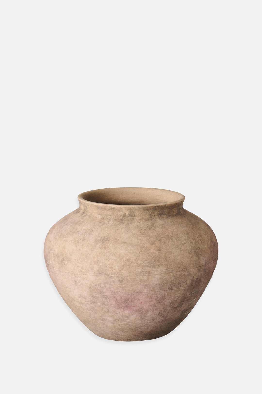 A rustic, rounded terracotta pot with a textured, earthy finish in shades of beige and light brown, set against a plain light gray background.