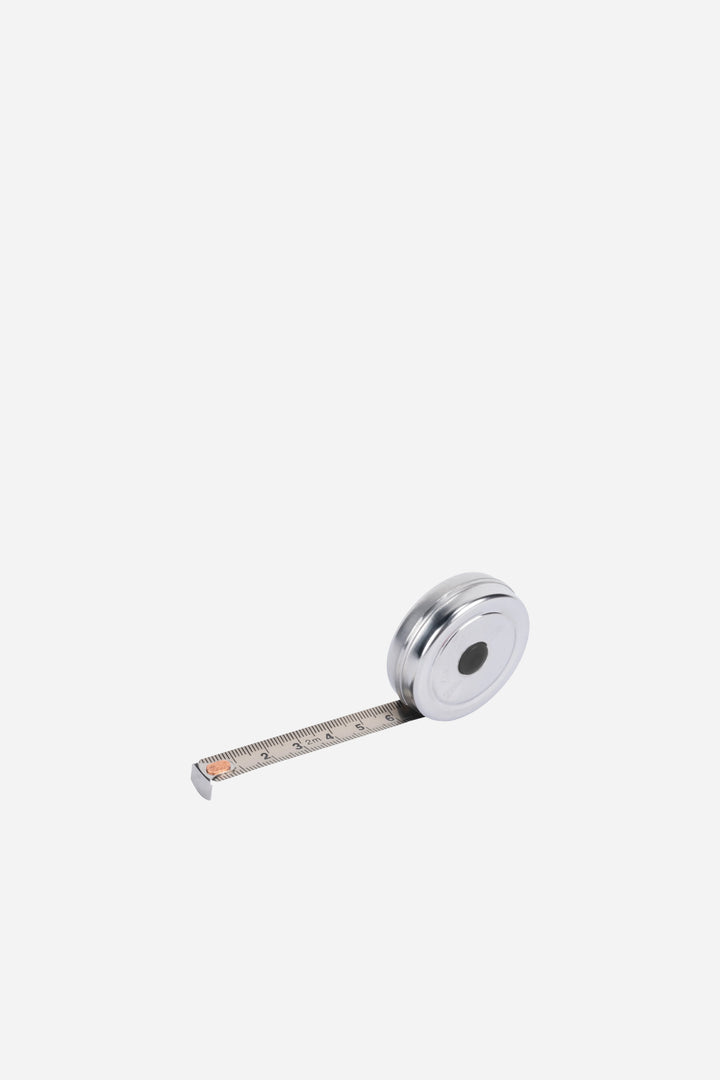 Metallic tape measure on a white background