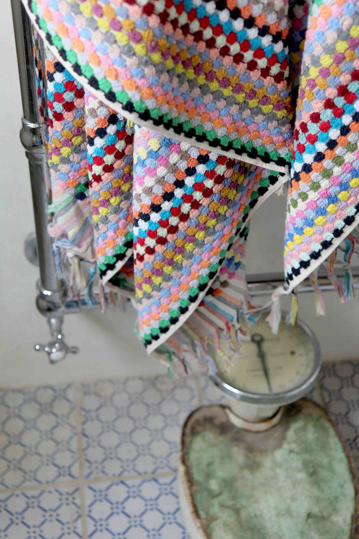 multicoloured turkish bath towel and vintage weighing scales
