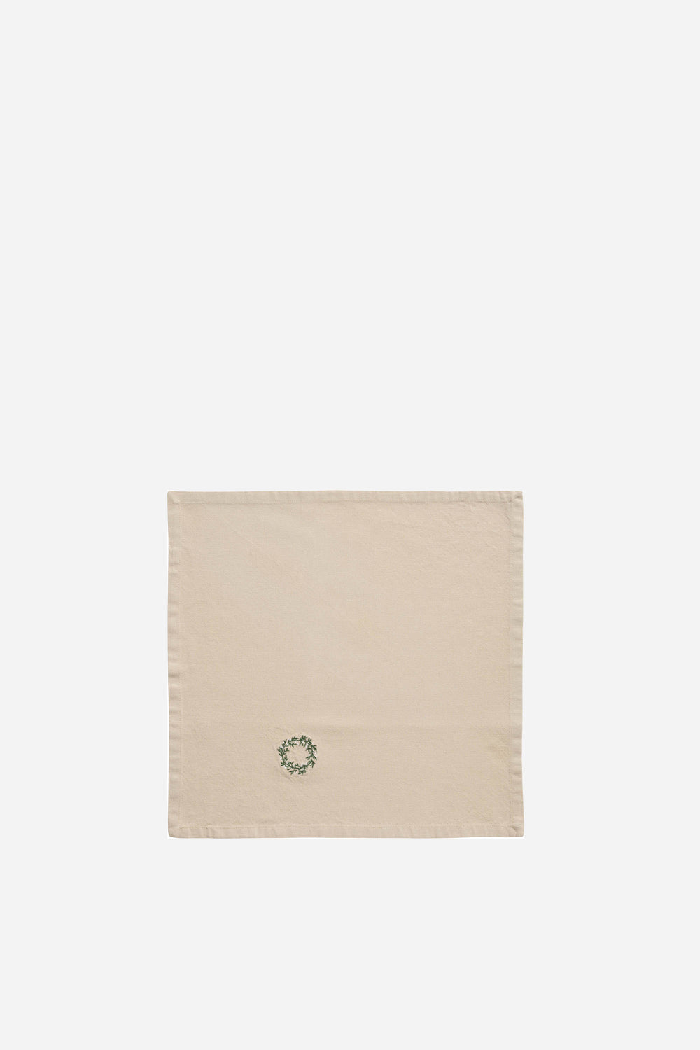 Beige towel with a green wreath design on a white background