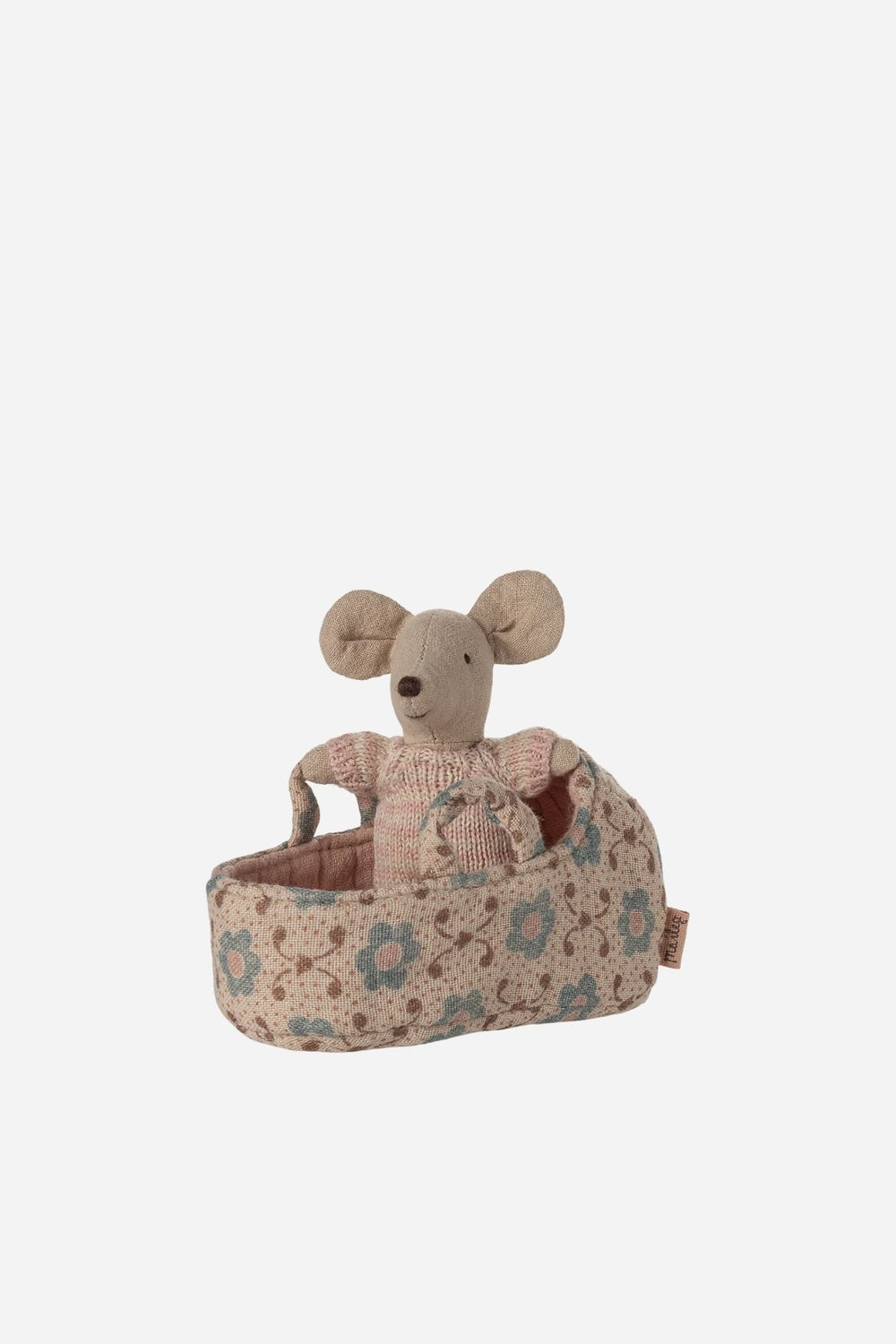 Small mouse plush toy in a floral bed on a white background