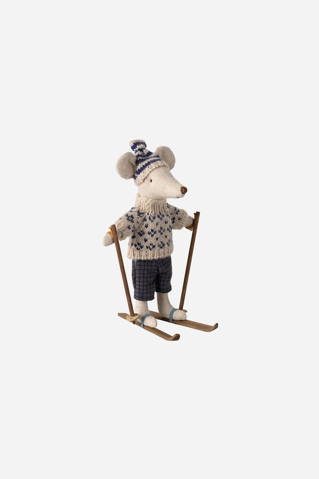 Small stuffed mouse in a sweater on skis on a white background