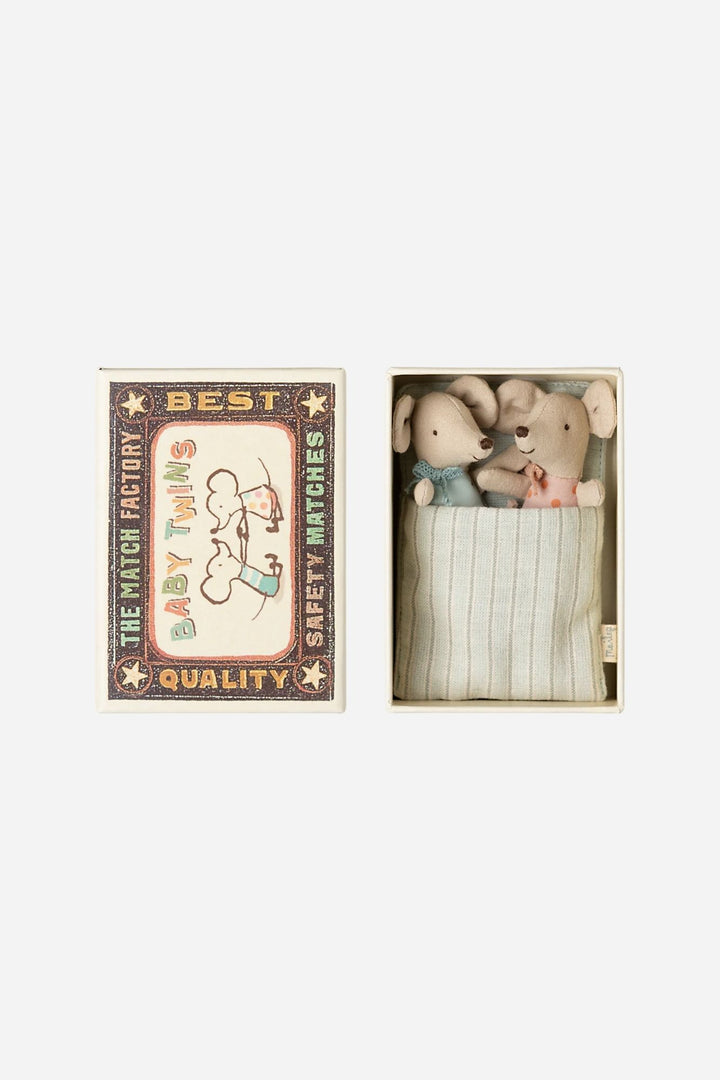 Two small stuffed mice in a box labeled 'Best Baby Twins' with a decorative matchbox design.