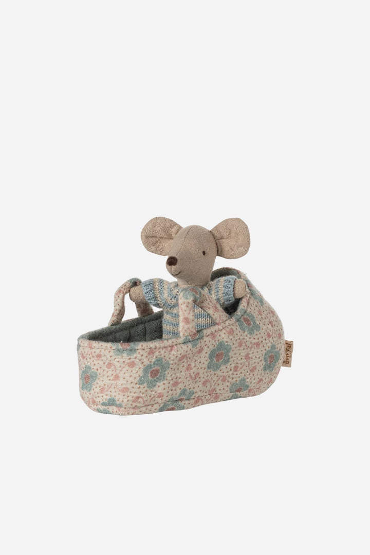 Stuffed mouse toy in a floral-patterned bed on a white background
