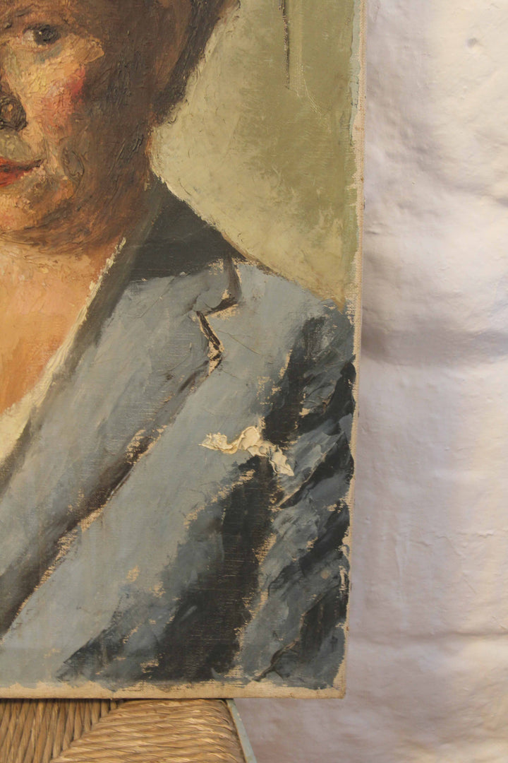 Close-up of a portrait painting with visible wear and tear on the frame.