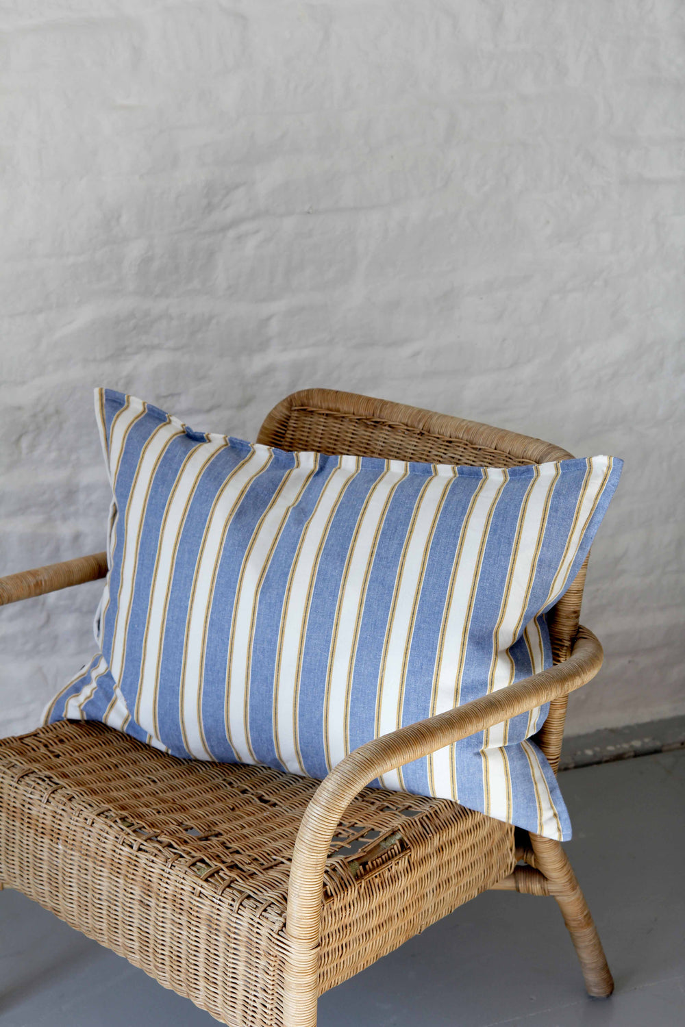 azur blue striped garden cushion on rattan chair